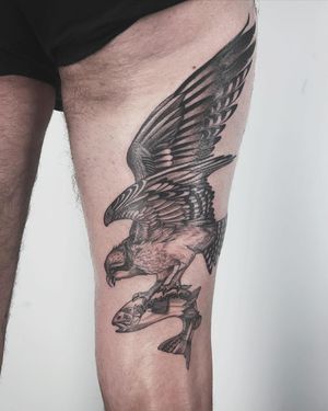 Get inked with a stunning black & gray fish and eagle tattoo by the talented Paula. Showcase the beauty of these powerful creatures with intricate details.