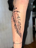 Nature-inspired fineline tattoo by Petra Zakoucka, Vancouver BC, blending botanical elements with minimal abstract linework. imprint of a real blackwork fern from West Coast