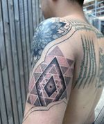 The Sri Yantra is not just a geometric figure—it is a door to higher states of consciousness. Its design was not created for rational interpretation, but to be contemplated as a direct spiritual experience. Through its structure, it guides the practitioner from the densest levels of existence to the point of unity with the Absolute. Each triangle, and line within the Sri Yantra acts as a frequency resonating with different aspects of the self. By meditating with this symbol, deep areas of the mind and energetic body are activated, allowing for the release of blockages and the expansion of perception. This process opens the path toward a broader consciousness aligned with cosmic intelligence. The central bindu represents the point of origin and return, where all duality dissolves. By reaching this center through practice, one enters a state of inner silence and unity with the All. The Sri Yantra, as a portal, reveals that the divine is not separate from the human being, but lives at their deepest core, waiting to be remembered. Sleeve in process on @alessiotraveler 🙏🌌 . . . . #cosmicarchitecture #geotattoo #geometrictattoo #sacredgeometrytattoo #dotwork #dotworktattoo #londontattoo #ink