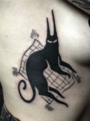 Get mesmerized by this stunning blackwork and illustrative tattoo of a black cat by Amandine Canata. Perfect for feline lovers!