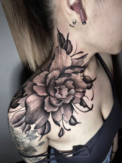 A stunning blackwork peony tattoo with intricate floral details, expertly done by Hamid.