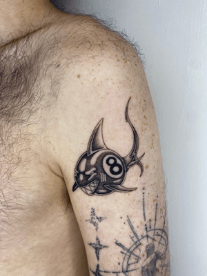 A unique black and gray tattoo combining a shark and an 8 ball in dotwork and new school styles by artist Charlie Macarthur.