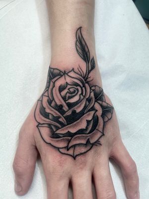 Get a beautifully detailed traditional rose tattoo by artist Marc 'Cappi' Caplen. Perfect for lovers of classic floral designs.