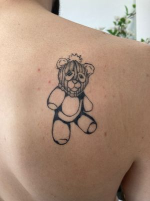 Unique blackwork and fine line tattoo featuring a bear wearing a mask, expertly done by renowned artist Robert Buckley-Warner.
