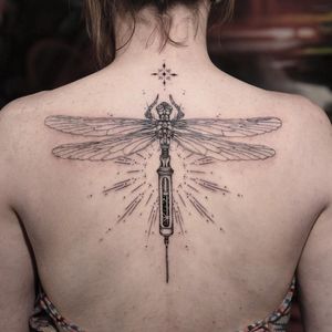 Fine line tattoo featuring a dragonfly, inspired by Coheed and Cambria with a syringe motif, by Sasha Davydova.