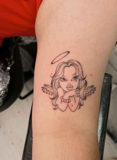 Elegant black and gray fine line cherub tattoo designed by the talented artist Sally.