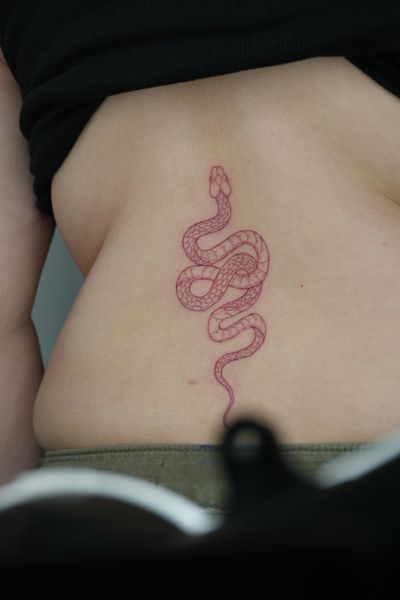 Get a unique fine-line and illustrative tattoo of a striking red snake by talented artist Lucas Scardua.