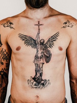 A stunning black and gray dotwork realism tattoo of an angelic archangel, intricately detailed by Gabriele Edu.