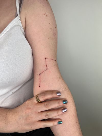 Get a stunning dotwork tattoo of your favorite constellation by the talented artist Emma InkBaby.