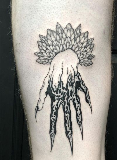 Get spooked with this blackwork horror hand tattoo by the talented Amandine Canata. Perfect for horror fans!