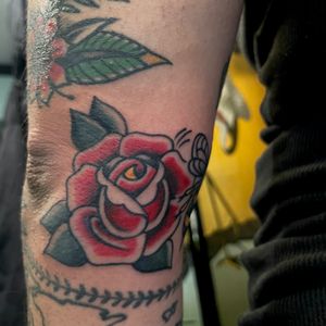 Adorn your skin with a timeless symbol of love and beauty in this traditional style rose tattoo by the talented artist Marc 'Cappi' Caplen.