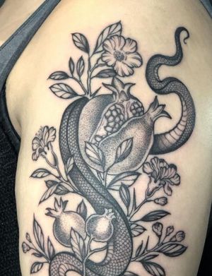 Beautiful dotwork tattoo featuring a snake and pomegranate fruit in a floral illustrative style by Amandine Canata.