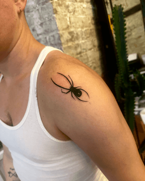 An illustrative blackwork tattoo of a menacing black widow spider, created by Miss Vampira.