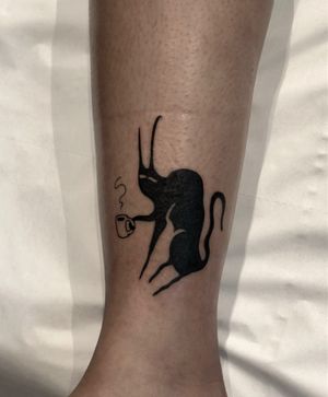 Embrace the mystery with this blackwork and illustrative cat tattoo inspired by Le Chat Noir. Designed by the talented artist Amandine Canata.