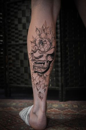 Blackwork and fine line style tattoo of a traditional Japanese oni mask, done by Steffan Eagle.