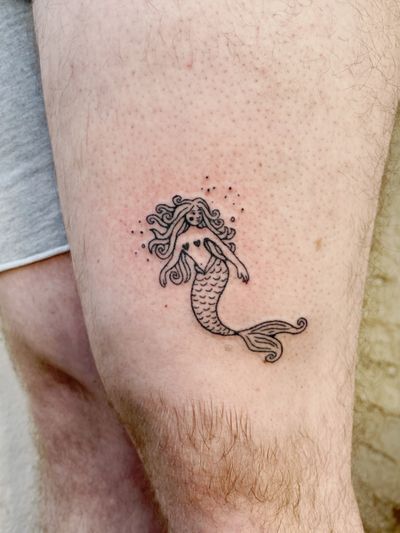 Laura's blackwork hand-poked mermaid tattoo captures the mystical beauty of the sea creature with intricate fine lines.