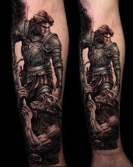 Saint Michael the Archangel in armour with wings and sculpted stone. Black and grey realism, two views. KAZENTATTOO, Los Angeles.
