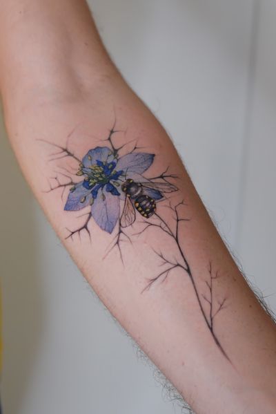 Stunning realism tattoo featuring a bee on a flower, intricately detailed by Maria. Perfect for nature lovers!