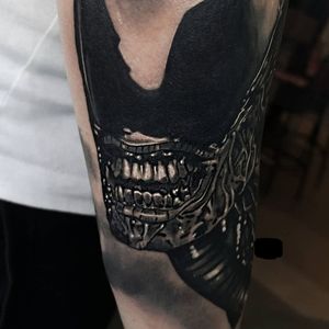 Embrace your inner sci-fi fan with this stunning black and gray realism tattoo of a xenomorph alien by acclaimed artist Craig Hicks.