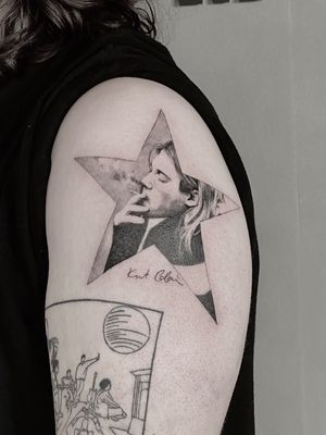 Capture the essence of Nirvana with this realistic black and gray star tattoo featuring a nod to Kurt Cobain's music. By Saka Tattoo.