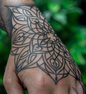Embrace the mesmerizing flow of this ornamental dotwork tattoo by Mona Noir Tattoo, featuring a unique organic pattern.