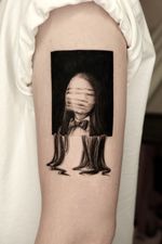A conceptual surreal portrait tattoo framed in black, with the face obscured by horizontal lines and the body dissolving into strands. This black and grey surreal realism piece explores identity fragmentation in a dreamlike composition.
