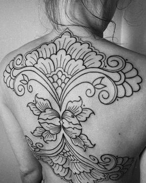 Elegant and intricate blackwork tattoo of a beautiful flower designed by tattsbybetts.