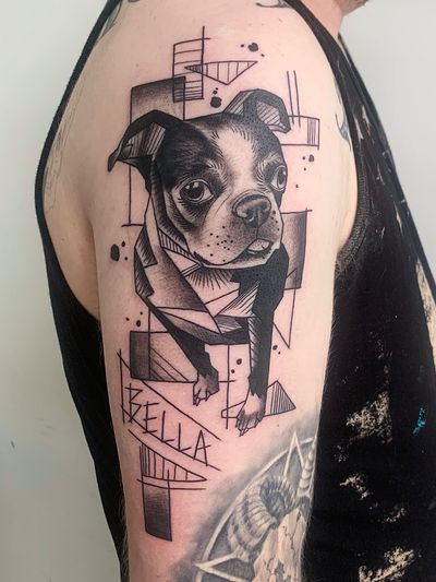 Abstract blackwork tattoo of a dog in small lettering, located in New York, US. Geometric and minimalist design.