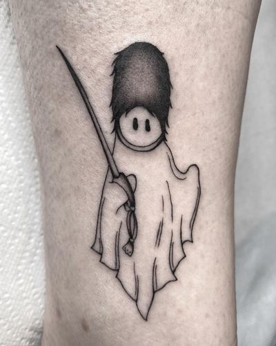 A haunting black-and-gray fine line tattoo of a ghostly king's guard wielding a saber, done by the talented artist Amandine Canata.