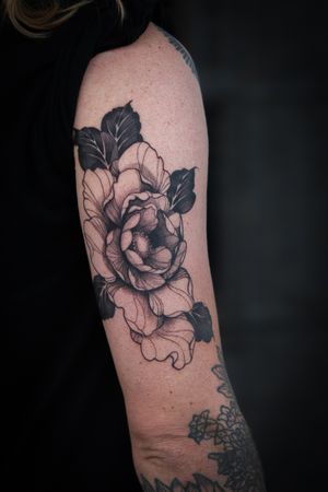 Admire the delicate details of this fine line blackwork flower tattoo, masterfully crafted by Steffan Eagle.