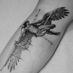 This black and gray fine line geometric tattoo pays homage to Greek mythology with a stunning micro-realism depiction of Icarus.