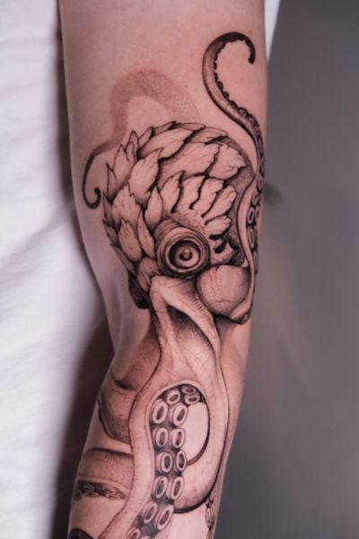 Stunning black and gray octopus tattoo by Maria, showcasing intricate details and skilled shading techniques.