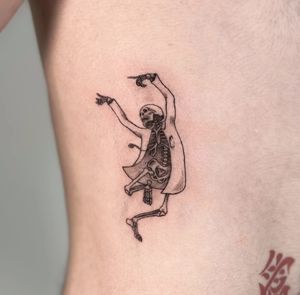 Illustrative tattoo by Jo Heatley featuring a cheerful skeleton in doctor attire.