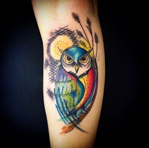 Vibrant new school watercolor owl design by artist Sandro Secchin for a unique and eye-catching forearm tattoo.
