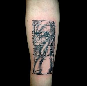Fine line forearm tattoo featuring a man within a frame, expertly done by Sandro Secchin.
