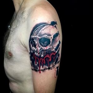 Bold trashpolka design featuring a menacing skull and dripping blood on the upper arm by the talented artist Sandro Secchin.