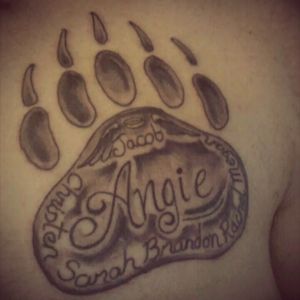 My third tattoo I got when I was 48 yrs old. The Bearpaw represents my nickname since I was young. My wife's name in the middle with my kids around the paw.