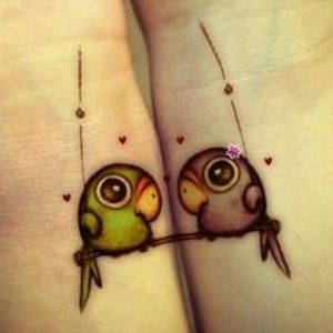 Cute and colorful friendship or mother/daughter wrist tattoo! # parrots # birds #friendshiptattoo