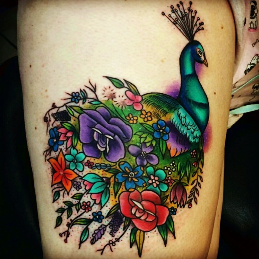 Peacock tattoo on the right thigh
