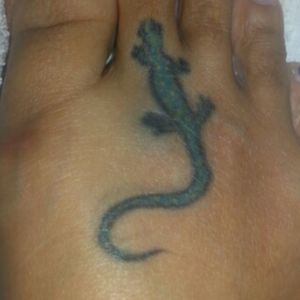 A salamander with a stylistic tail (with light shadow) -Designed by ME and my tattoo artist jointly-Based on actual pic of salamander, except tail which was stylized to increase coverage area on top of foot. -Done in 2008, so bit faded but 5+ colours in body/tail plus black for outline