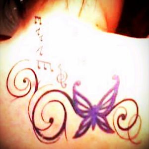 First tattoo was the butterfly, then came the musical notes...then the swirls