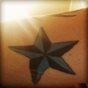 Blue natical star back of arm