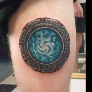 Stargate tattoo with the symbols from the show replaced with birthdays, best times, and other geeky things. Tattoo done by Damion Cressy at Electric Dragonland in Minnesota.