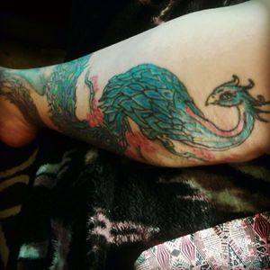 The peacocks tail wraps round the bottom of my leg to the top of my foot.
