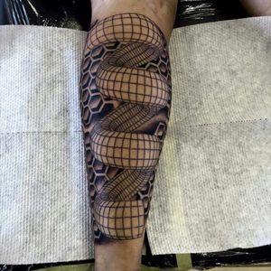 A geometrical spiral with a honeycomb background done by jason at jbm
