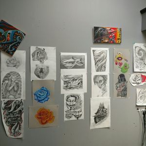 Some of my drawings on the wall the shop inkfam tattoo gallery indianapolis Indiana