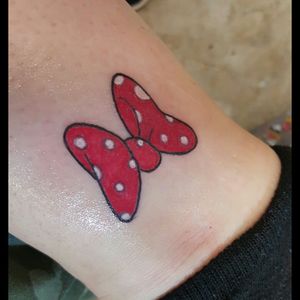 Minnie Mouse bow on inside of ankle.