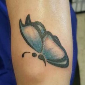 Semicolon butterfly above left wrist.