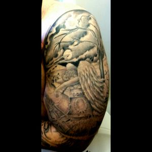#upperarm #memorialtattoo An angel weeping over the 1 grave in a dark and eery graveyard.