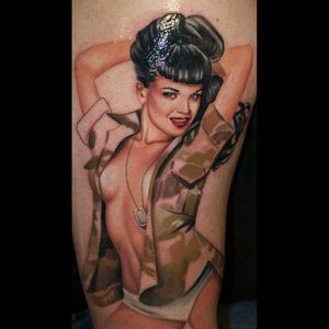 My first tattoo. A color portrait of Bettie Page wearing an old Army jacket and dog tags. A tribute to the queen of pinups. She's not quite finished yet. I have to get her jacket sleeve colored in and I'll be going back to get a background added.